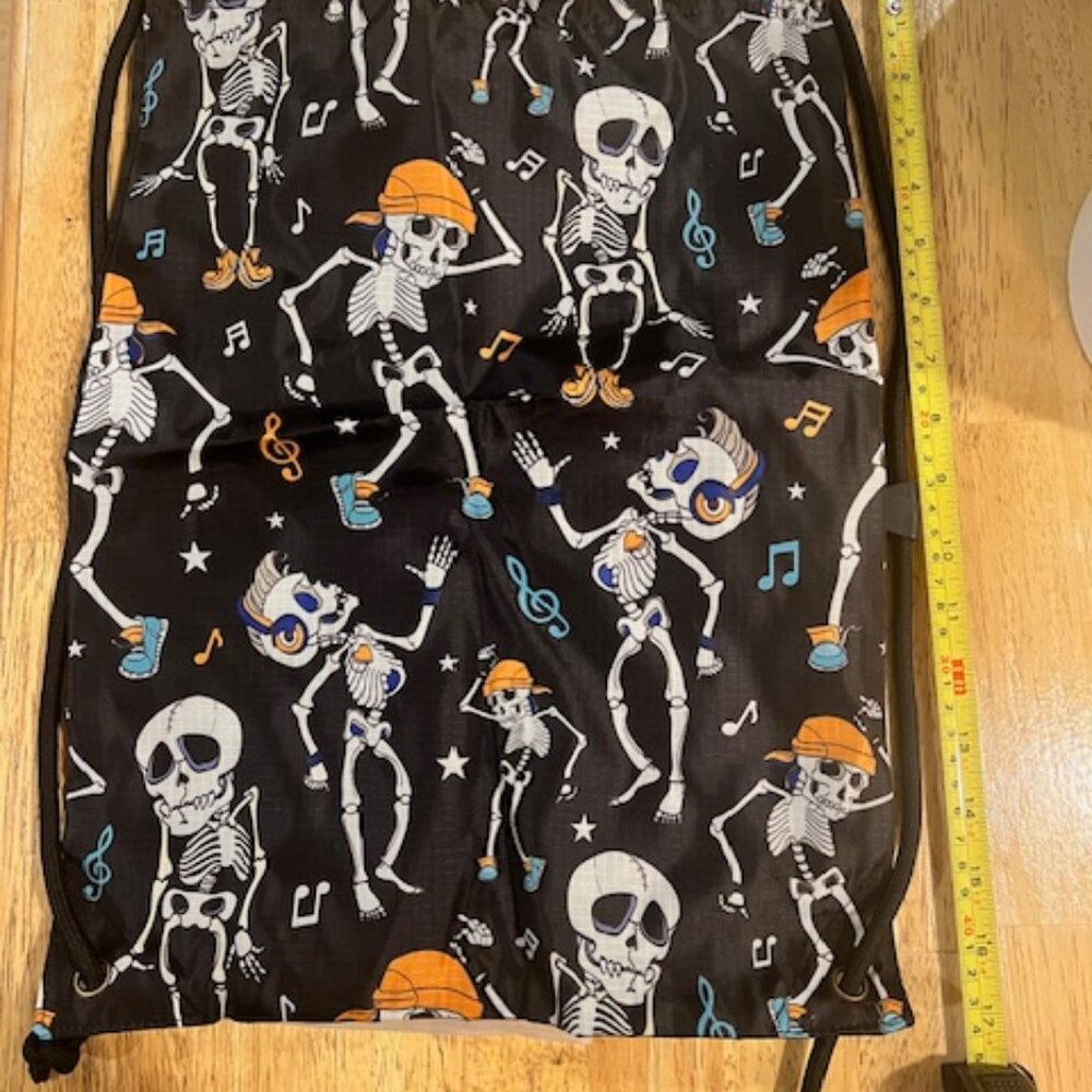 black drawstring backpack‎ vibrant all-over print of dancing skeletons & notes